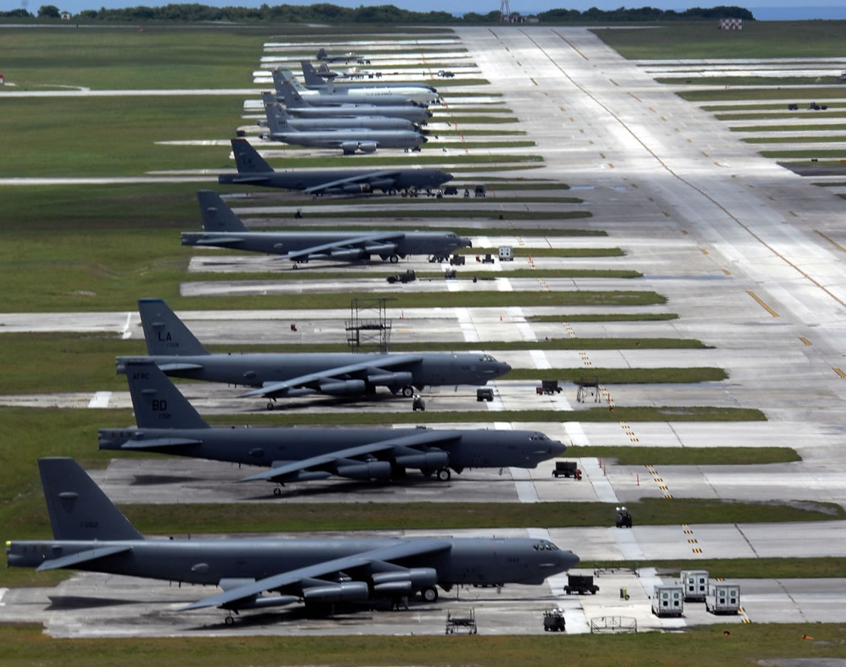 Rows of large military aircraft parked on a vast airstrip at Barksdale Air Force Base, surrounded by grassy fields.