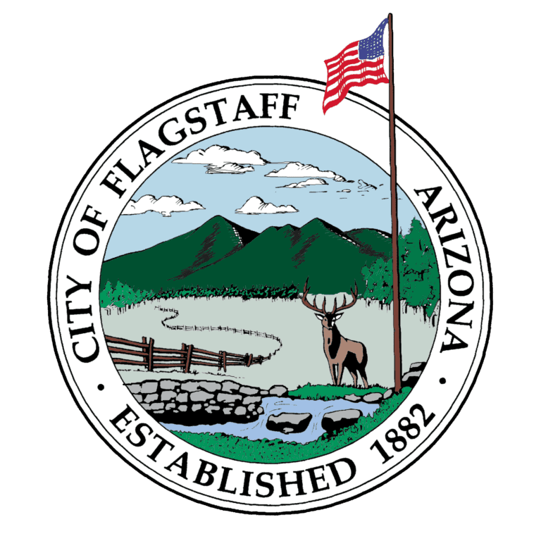 Logo of the city of Flagstaff, Arizona, featuring a deer in a forest under a mountain range, with an American flag and the text "Water Projects Established 1882".